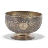 Victorian small circular pedestal bowl chased and embossed with floral and foliate designs, a