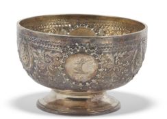 Victorian small circular pedestal bowl chased and embossed with floral and foliate designs, a