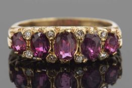 Victorian garnet and diamond ring featuring five graduated oval cut garnets, highlighted between