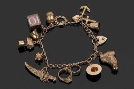 9ct gold curb link bracelet suspending various 9ct gold charms to include a dagger and scabbard