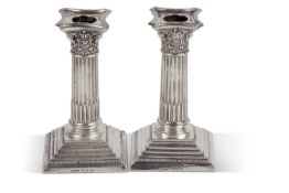 A pair of late Victorian silver encased dressing table candle sticks in neo-classical style having