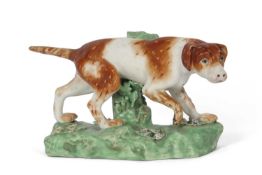 Early 19th Century Derby model of a retriever on a green coloured base, 18cm long (restoration to