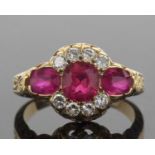 Ruby and diamond triple cluster ring featuring a cushion cut ruby, two oval rubies and eight round