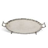 George V two handled tea tray of shaped oval design with 'pie crust' edge and supported on four hoof