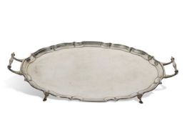 George V two handled tea tray of shaped oval design with 'pie crust' edge and supported on four hoof