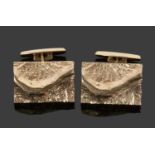 Pair of 750 stamped cuff links, the rectangular panels a stylised polished and textured design,