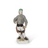 19th Century Meissen model of a miner in typical pose, cross swords and impressed numerals to