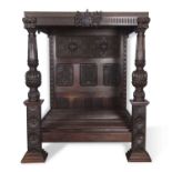 Large Elizabethan style dark oak tester bed with heavy ribbed posts and intricate floral and foliate