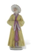 Mid 18th Century figure possibly Meissen of a chinaman with a smiling face in a yellow cloak, 12cm