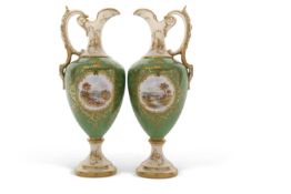 Pair of late 19th Century Coalport ewers, the green ground with gilt decoration surrounding