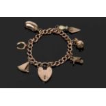 Antique 9ct gold curb link bracelet suspending five various 9ct charms and an unmarked trowel charm,