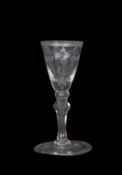 Georgian wine glass with swag engraving to the fluted bowl and triple knop above a clear stem,