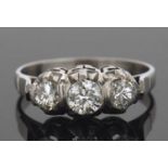 Diamond three stone ring featuring three graduated round brilliant cut diamonds, bezel and claw set,