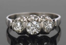 Diamond three stone ring featuring three graduated round brilliant cut diamonds, bezel and claw set,