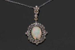 Opal and diamond pendant, the oval cabochon opal within a small old cut diamond surround all in an