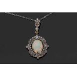 Opal and diamond pendant, the oval cabochon opal within a small old cut diamond surround all in an