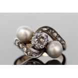 Diamond and pearl crossover ring featuring a round old cut diamond 0.30ct approx, and two pearls set