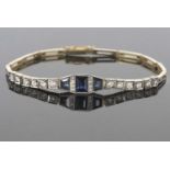 Precious metal sapphire and diamond line bracelet centering three calibre cut sapphires and two