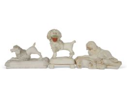 Group of three mid 19th Century dog models on shaped bases including a Derby example on a rococo