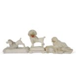 Group of three mid 19th Century dog models on shaped bases including a Derby example on a rococo