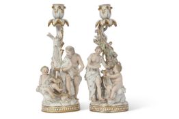 A fine pair of Meissen porcelain candlesticks, 19th Century, one decorated with elderly man and
