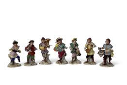 Group of seven early 20th Century Dresden monkey band figures including a conductor, drummer and