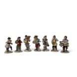 Group of seven early 20th Century Dresden monkey band figures including a conductor, drummer and