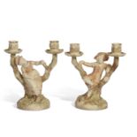 Pair of Worcester Hadley candlestick figures modelled as children leaning against branches with