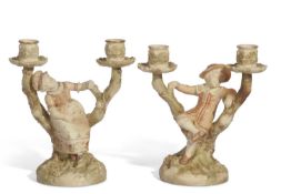 Pair of Worcester Hadley candlestick figures modelled as children leaning against branches with