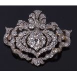 Diamond brooch/pendant, a floral an scrolled design decorated with graduated old cut diamonds