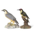 Royal Crown Derby large porcelain model of a falcon seated on rock work together with a Royal