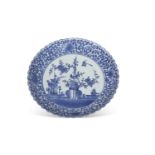 Large Japanese porcelain charger with typical blue and white designs within scrolling foliate
