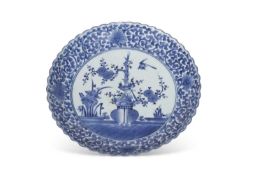 Large Japanese porcelain charger with typical blue and white designs within scrolling foliate