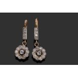 A pair of diamond drop earrings comprising a cluster of old cut diamonds all in rub-over milgrain