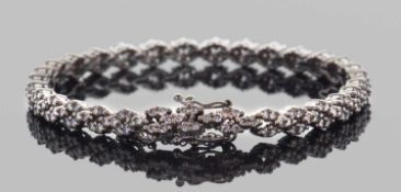 Precious metal diamond set bracelet, each articulated link set with 6 small round brilliant cut
