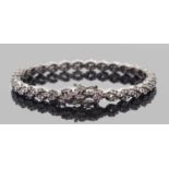 Precious metal diamond set bracelet, each articulated link set with 6 small round brilliant cut