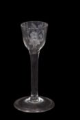 A wine glass, the ogee bowl with engraved floral decoration above a clear stem, 15cm high