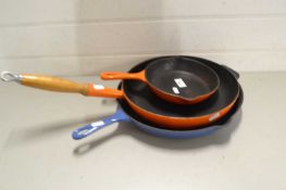 Three various iron frying pans to include Le Creuset