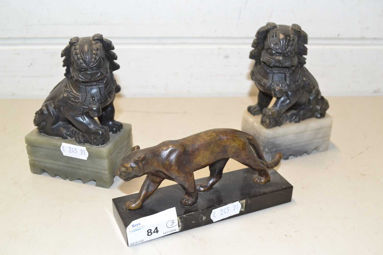 Small bronze model of a lioness, 20th Century together with two Foo dogs