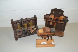 Three stands, various tobacco pipes