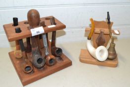 Two stands various tobacco pipes