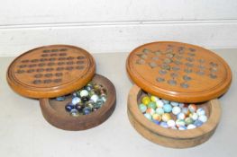 Two Solitaire boards with marbles