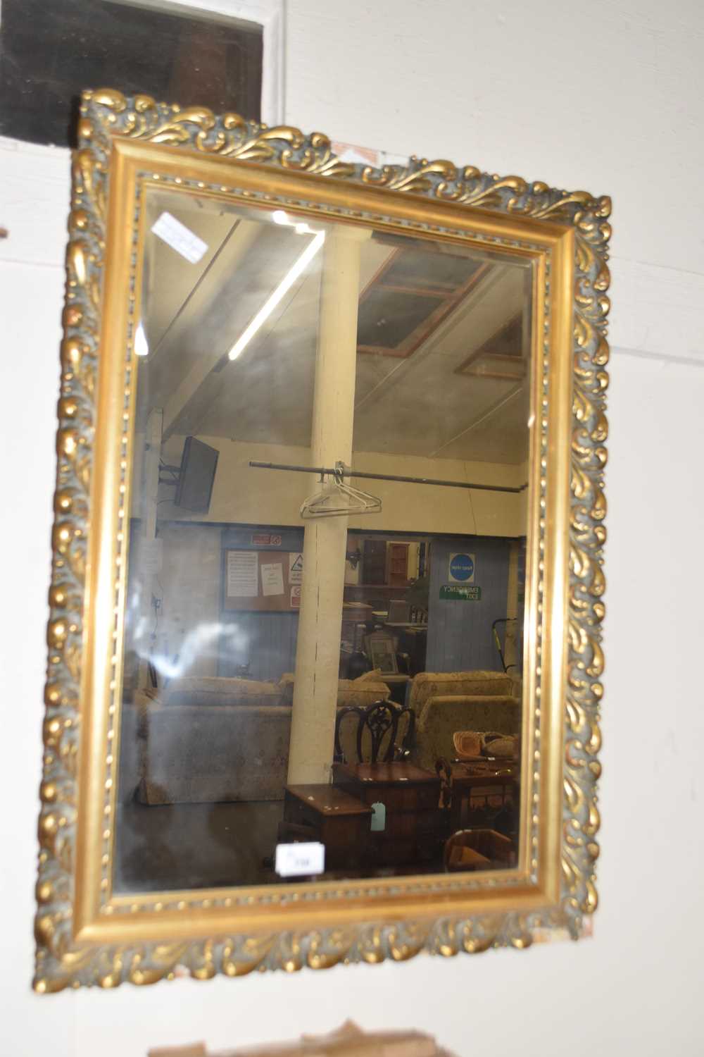 Beveled wall mirror in gilt finish frame