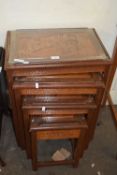 Nest of four Chinese hardwood glass top tables