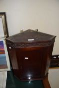 Small mahogany wall mounted corner cabinet