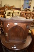 Small oak corner cabinet with arched panel door