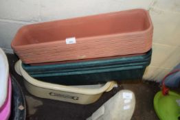 Quantity of plastic planters and a large ceramic pot marked Canning