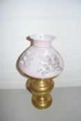 Brass oil lamp, the pink shade decorated with prints of birds