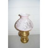 Brass oil lamp, the pink shade decorated with prints of birds