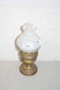 A small brass oil lamp with shade